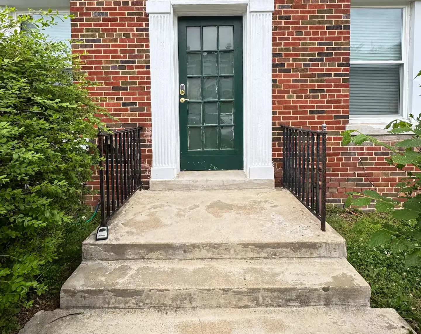 The green front door of the Manor Place NW rowhouse